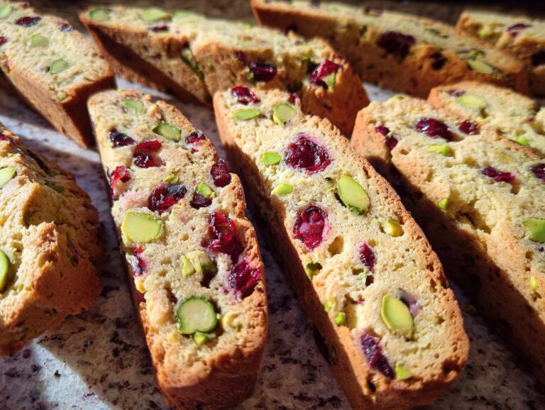 Close-up of homemade Cranberry Pistachio Biscotti, showing cranberries and pistachios baked inside.