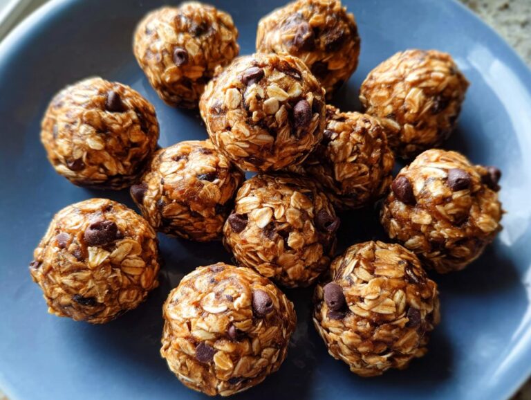 A cluster of homemade no-bake protein ball treats made with oats and chocolate chips on a blue plate.