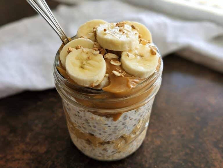 Close-up of Banana Peanut Butter Overnight Oats topped with banana slices and creamy peanut butter.