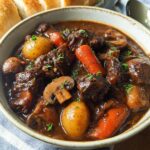 Close-up of a hearty bowl of Beef Stew With Mushrooms, featuring tender beef, carrots, potatoes, and mushrooms.