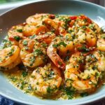 A close-up of plump shrimp coated in a rich sauce made with garlic butter and fresh parsley, known as Garlic Butter Shrimp.