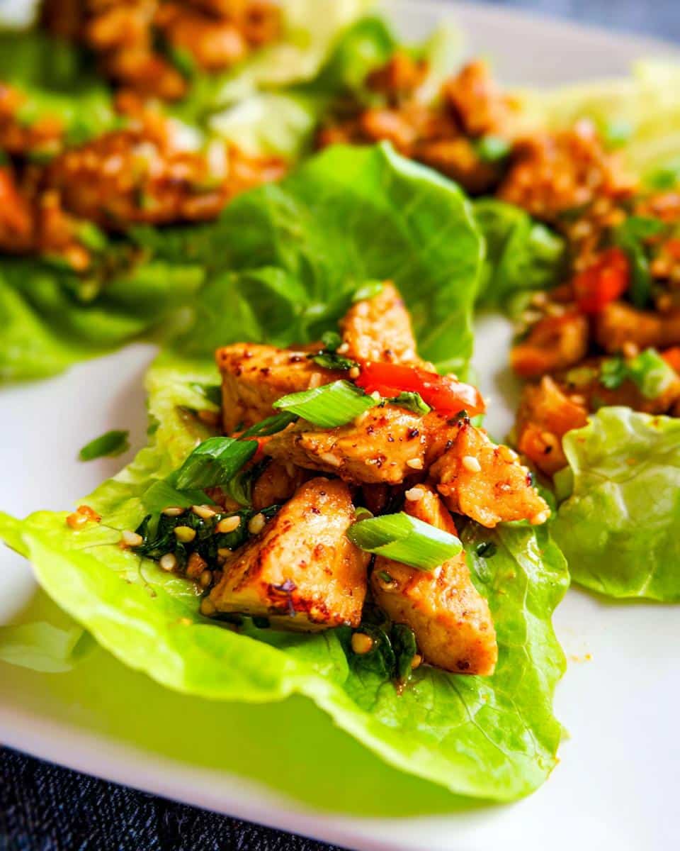 Close-up of seasoned chicken filling served in crisp lettuce cups for Low Carb Chicken Lettuce Wraps.